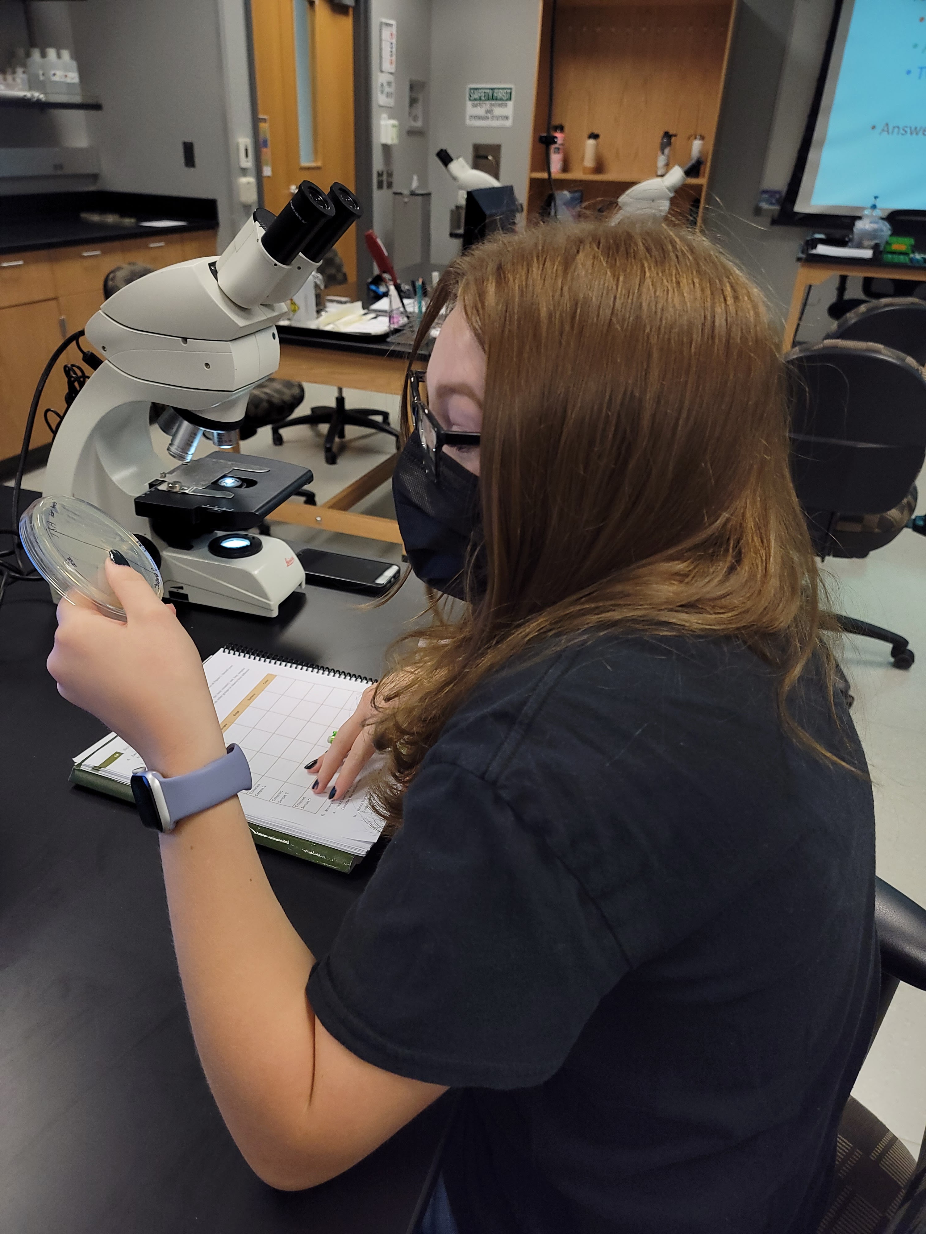 student with petri dish