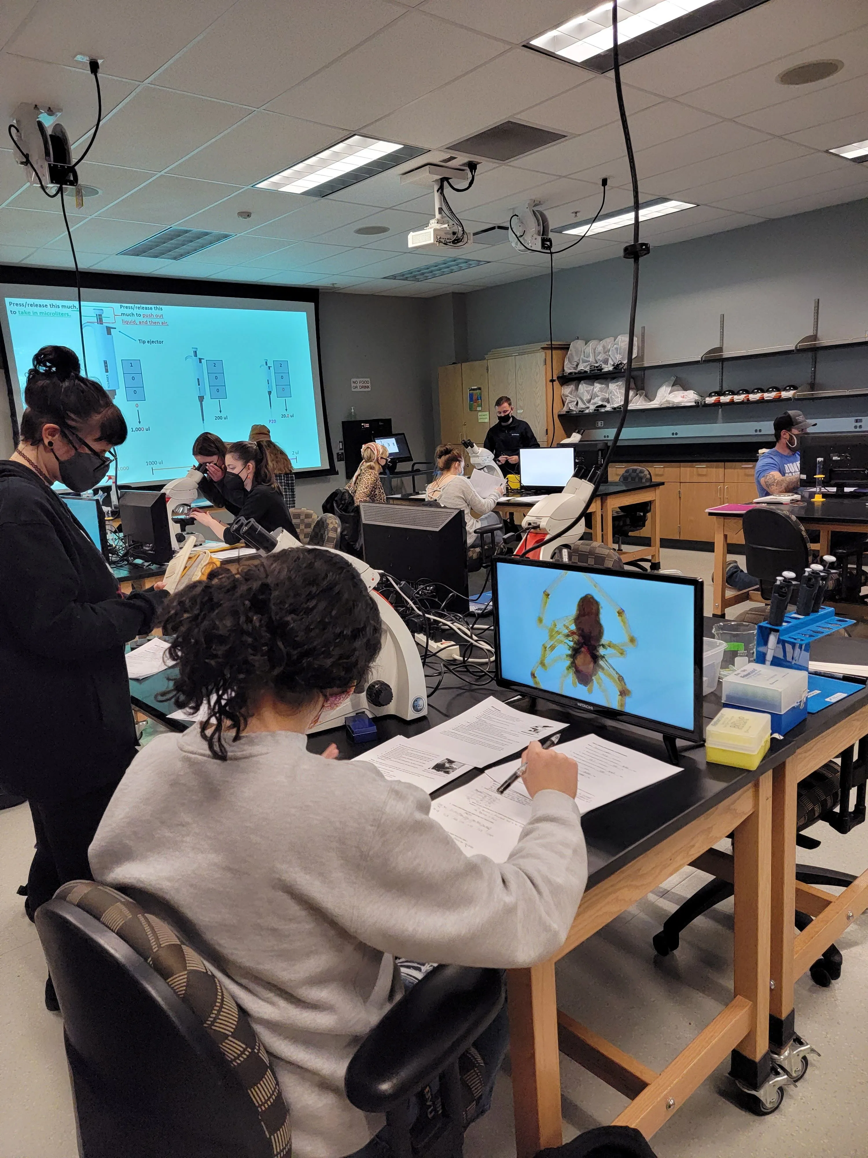 students using digital microscopes in biology lab